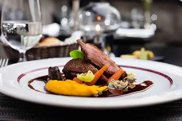 Roasted duck fillet with carrot-orange puree, slow-cooked duck heart and prune sauce