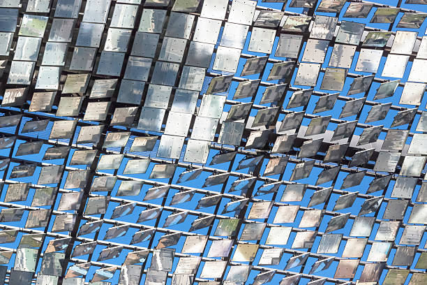 Heliostat, low angle view of motorised mirrors, copy space Low angle view of heliostat of motorised mirrors with reflection on high rise building Sydney Australia, full frame horizontal composition with copy space concentrated solar power photos stock pictures, royalty-free photos & images