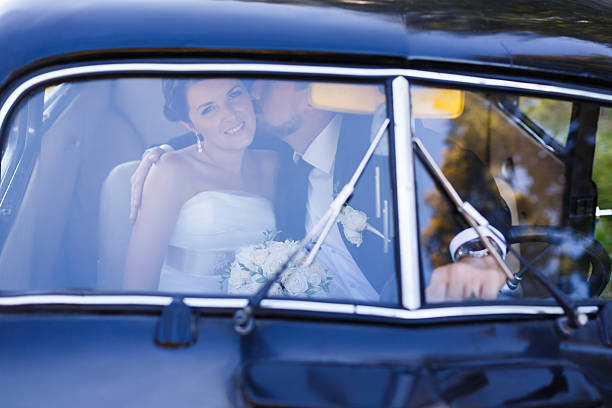 istock Wedding couple in old car 483796160