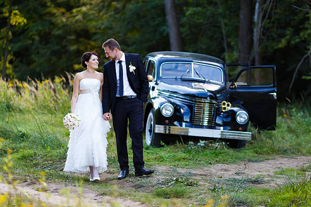 istock Wedding couple with old car 483796166