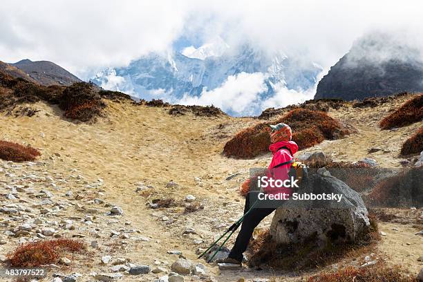 Woman Tourist Backpacker Resting Rock Ama Dablam Mountain Trail Stock Photo - Download Image Now