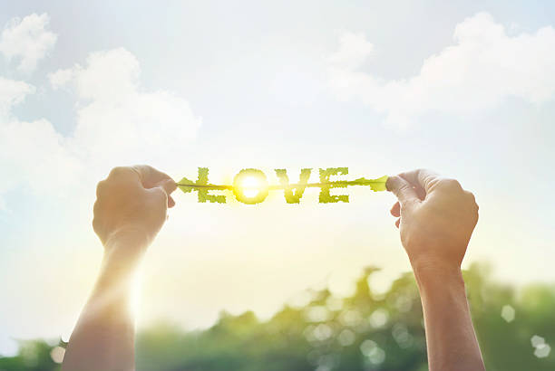 istock abstract, holding a green leaf in the word love 483798118