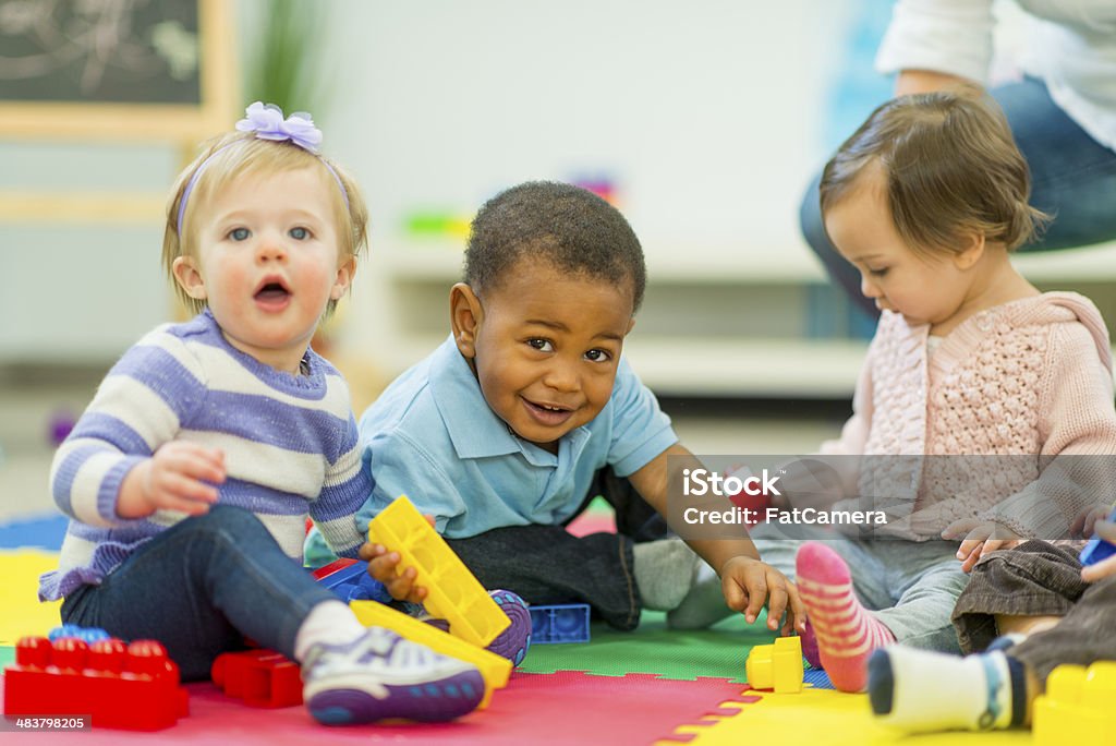 Babies Playing Diverse group of babies playing. Child Care Stock Photo