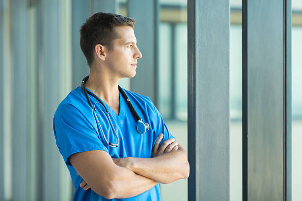 doctor looking through office window stock photo