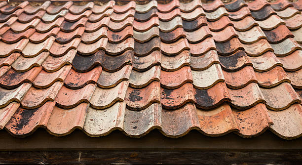 istock The old roof covered with orange tiles 483799020