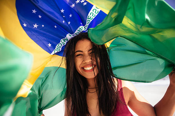 istock Cheering woman under brazilian flag 483800807