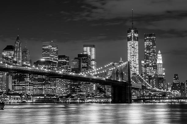 Brooklyn Bridge and Manhattan skyline at night Brooklyn Bridge and Manhattan skyline at night in black and white brooklyn bridge photos stock pictures, royalty-free photos & images