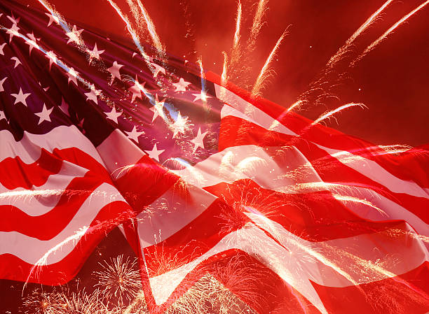 istock fireworks over United States flag 483801925