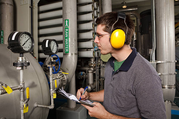 Reverse Osmosis Water Purification Plant Technician Checks System Settings A technician in a reverse osmosis plant. aquatic plant stock pictures, royalty-free photos & images