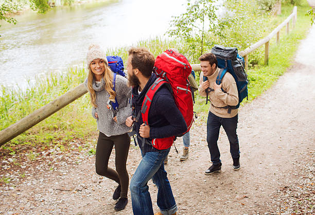 istock group of smiling friends with backpacks hiking 483802752
