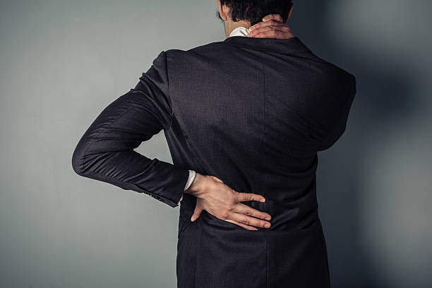 istock Businessman with sore back and neck 483802885