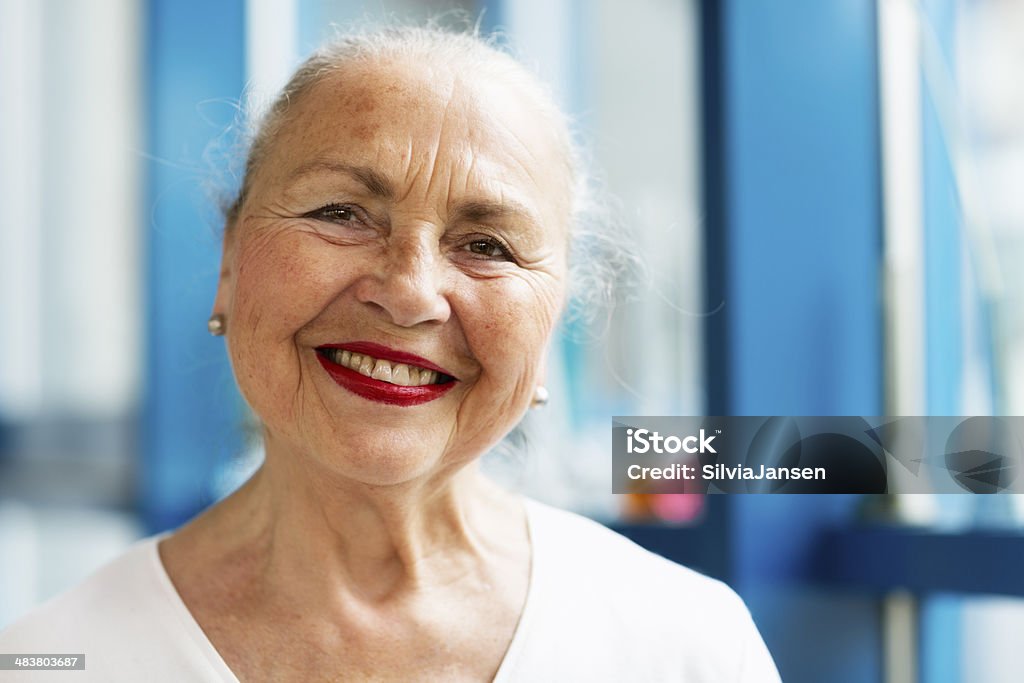 elegant cheerful senior woman portrait elegant senior woman, smiling, wearing red lipstick 60-69 Years Stock Photo