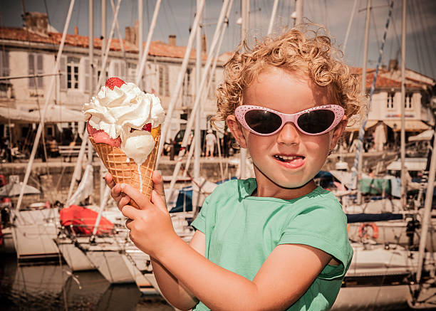 Big ice-cream! Child holding a really big ice-cream. licking ice cream cone stock pictures, royalty-free photos & images