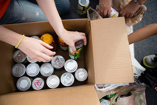 Volunteers Boxing Cans at Food Drive stock photo