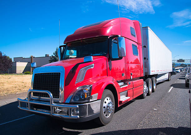 istock Red fency big rig semi truck modern trailer interstate highway 483808468