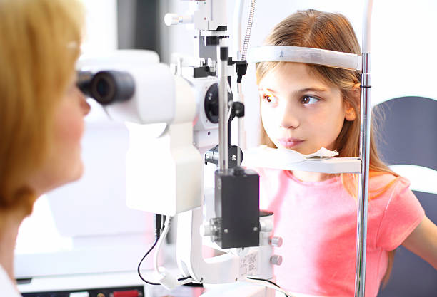 istock Little girl at optician. 483809414
