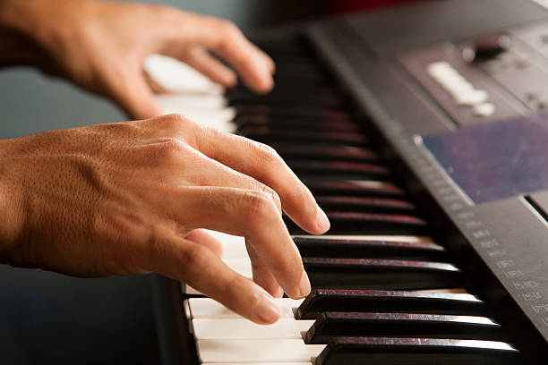 istock Young man playing the keyboard piano. Pianist, musician. 483809614