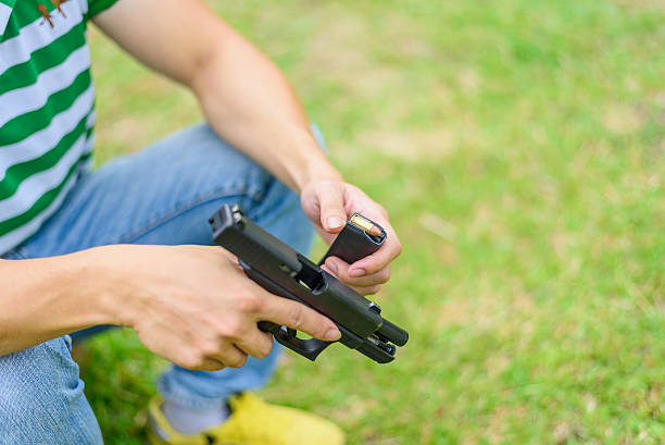 istock Gun man hand on green background 483812142
