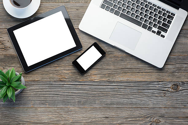 istock Digital tablet, laptop and smart phone on a wooden table. 483812156