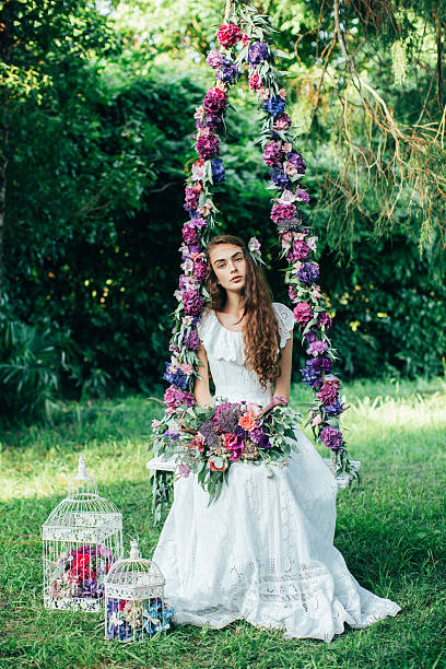 istock Beautiful young girl on a swing 483812320