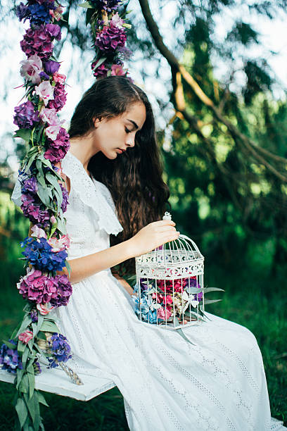 Beautiful young girl on a swing