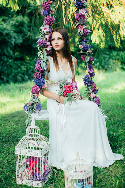 istock Beautiful young girl on a swing 483812534