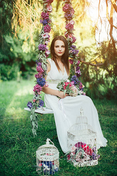istock Beautiful young girl on a swing 483812536