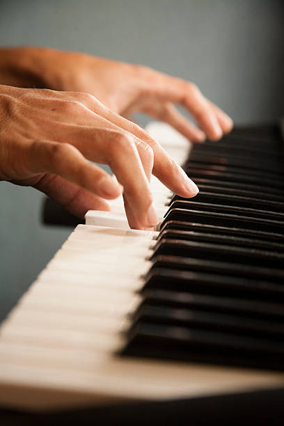istock Young man playing the keyboard piano. Pianist, musician. 483812562
