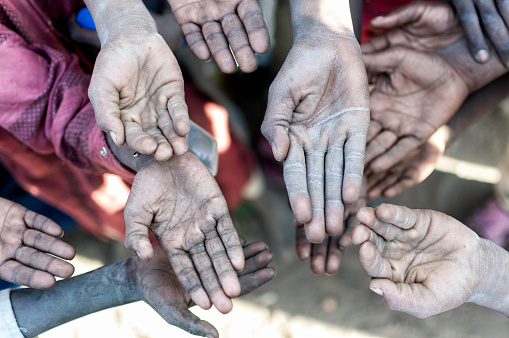 Hands of african poor people asking for HELP
