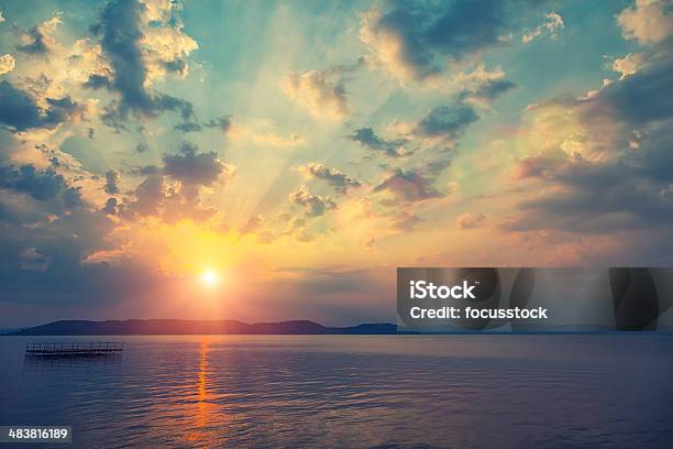 Sunset Over Water Stock Photo - Download Image Now - Sky, Sunset, Above