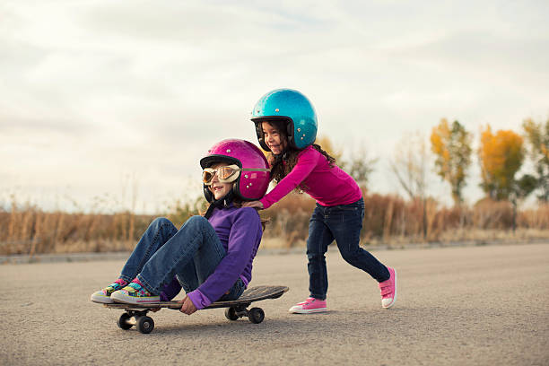 Zip Zoom All you need is a little imagination and a willing friend to go places, fast.  girls playing stock pictures, royalty-free photos & images