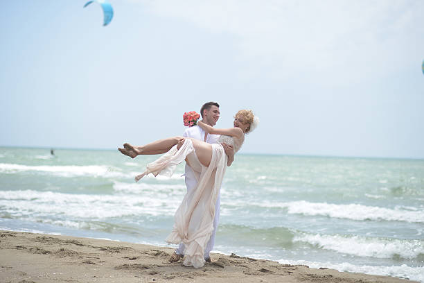 istock Smiling wedding couple on beach 483817434
