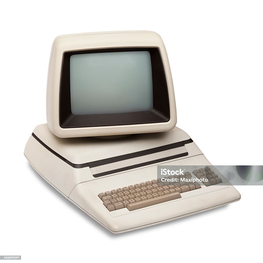 Vintage old computer, rounded monitor, keyboard, eighties revival, white background Vintage old computer from the eighties, with integrated monitor and keyboard. Retro revival style with rounded corners, left side top view, isolated on white background with clipping path. 1980-1989 Stock Photo