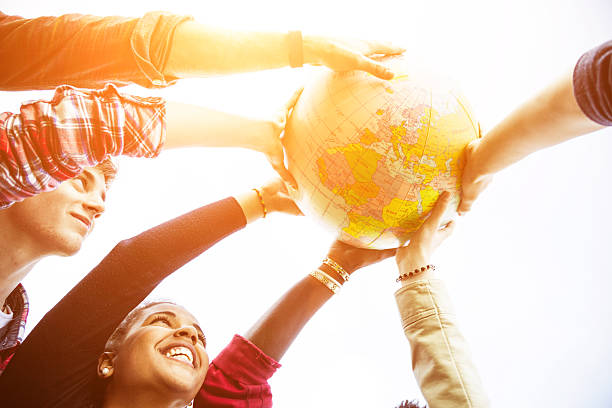 istock Group of teenagers holding an earth globe 483819713
