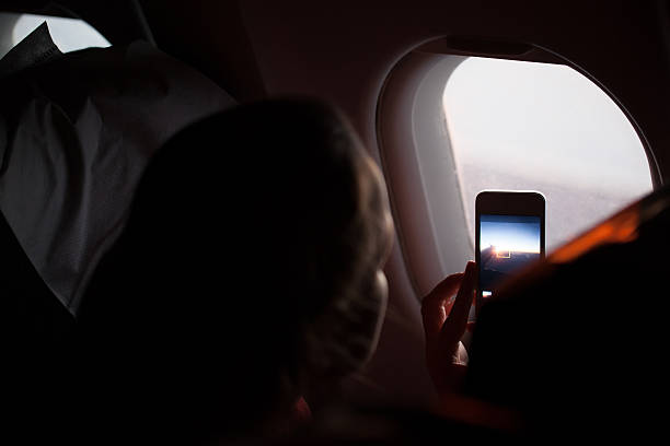 istock Woman taking photographs through a cabin porthole 483819721