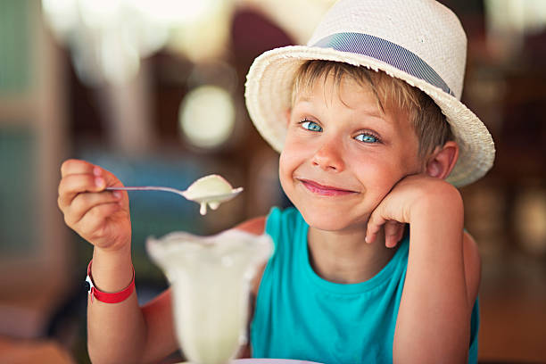 Little boy eating ice cream at restaurant