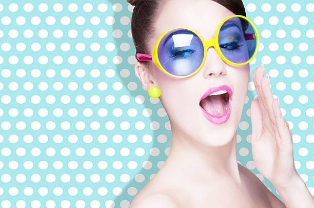 Attractive surprised young woman wearing sunglasses stock photo