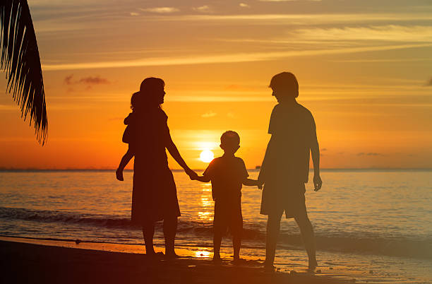 istock happy family with two kids on sunset beach 483821764