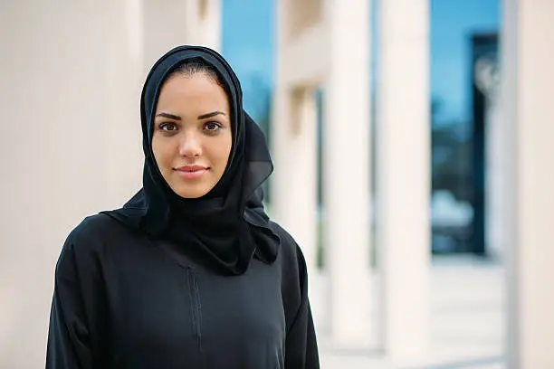 Portrait of young woman in traditional arabic clothes.
