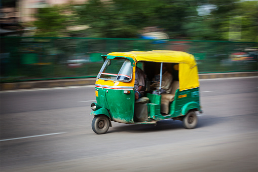 Indian auto (autorickshaw) taxi in the street. Motion blur. India