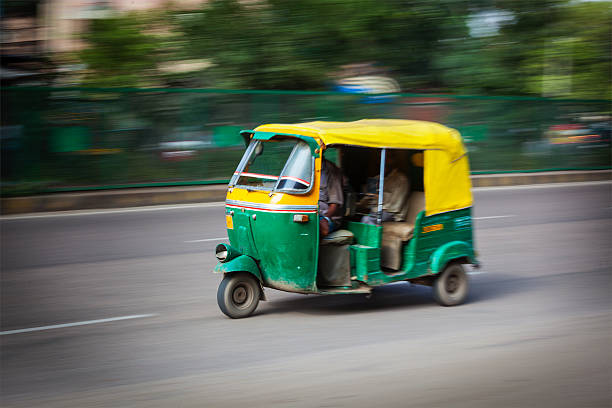 Indian auto (autorickshaw) in the street. Delhi, India Indian auto (autorickshaw) taxi in the street. Motion blur. India auto rickshaw taxi india stock pictures, royalty-free photos & images