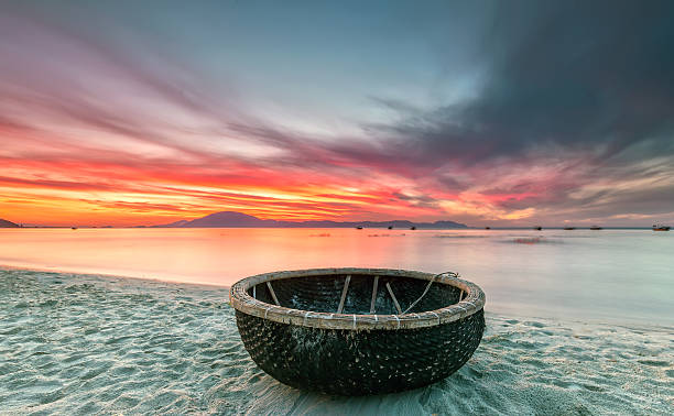 Welcome basket boat sunrise Welcome basket boat sunrise when the sun is not yet awake long exposures do move into a trail cloudy horizon glowing halo radiating beautifully basket boat stock pictures, royalty-free photos & images