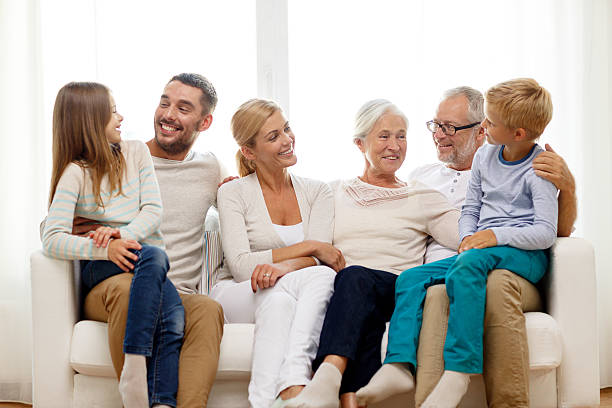 istock happy family sitting on couch at home 483826674