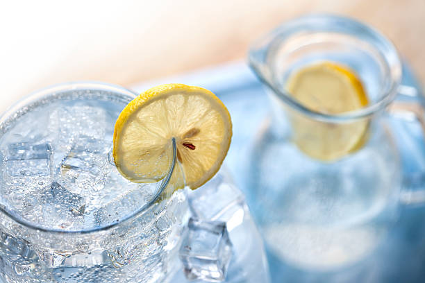 drink with ice cubes and lemon