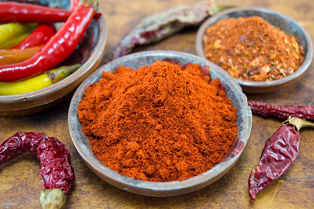 istock Fresh, dried, grounded, chopped and whole peppers in natural woo 483830606