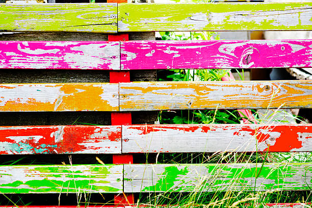 istock multicolored wooden fence with grass 483832070