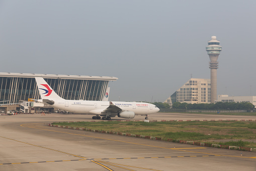 Shanghai, China - August 1, 2015: Airplane move past the Shanghai Pudong International Airport, China. It is the international airport serving Shanghai. 