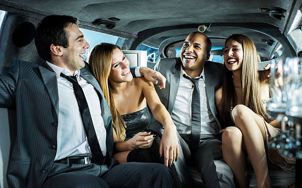 istock Cheerful young men and women sit in a limousine 483832927