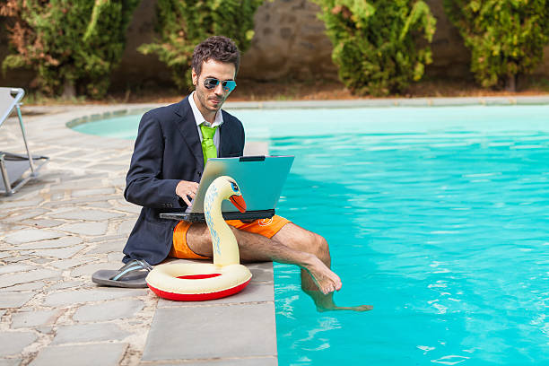 lustiger junge geschäftsmann mit swimmingtrunks neben dem pool - swim truncks stock-fotos und bilder