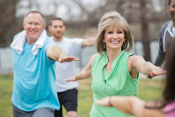 istock Active seniors stretching during outdoor fitness class 483836933